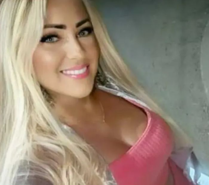 Blonde woman smiling at the camera wearing a pink top, related to angel-faced serial criminal chilling confession news. Blonde woman smiling at the camera wearing a pink top, related to angel-faced serial criminal chilling confession news.