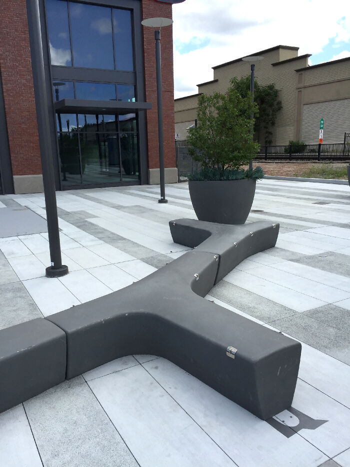 Curved bench and planter creating a clever shadow art installation that brings an ordinary object to life outdoors.