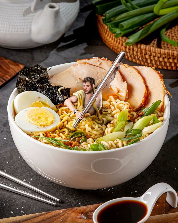 Bowl of ramen with egg, chicken, and a miniature man holding chopsticks in a logic-challenging photo manipulation.