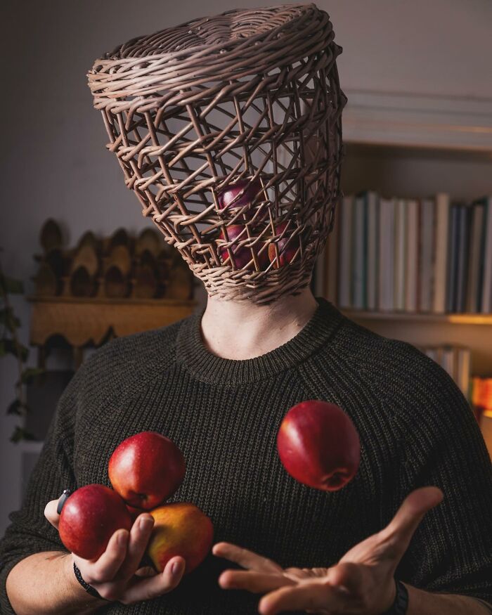 Man with a woven basket over his head and apples inside, juggling apples in a logic-challenging photo manipulation.