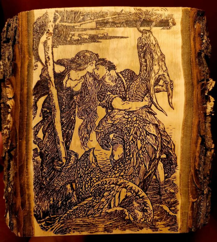 Wood-burned artwork by Canadian artist Kat Slota depicting a detailed, intricate scene created using fire on wood.