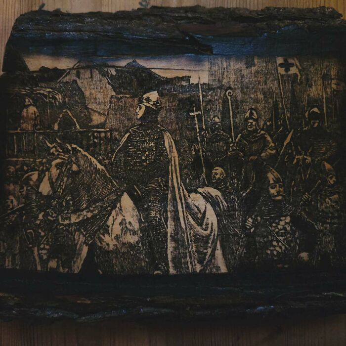 Wood-burned artwork by Canadian artist Kat Slota depicting medieval figures and a horse using fire techniques on wood.