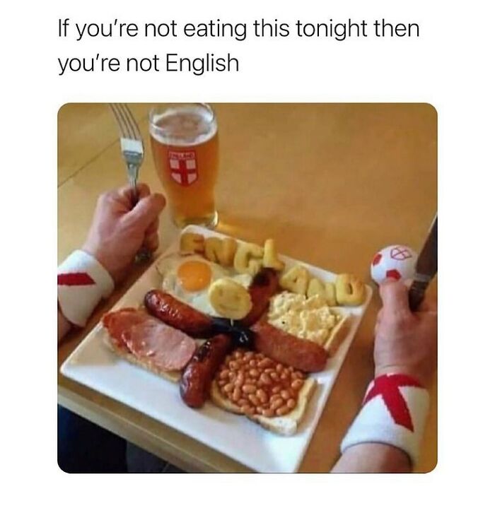 Plate of full English breakfast with sausages, beans, egg, and bread, captioned with unapologetically British humor.