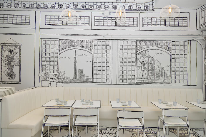 2D restaurant interior in NYC with black and white drawings on walls and furniture creating a cartoon-like dining experience 2D restaurant interior in NYC with black and white drawings on walls and furniture creating a cartoon-like dining experience