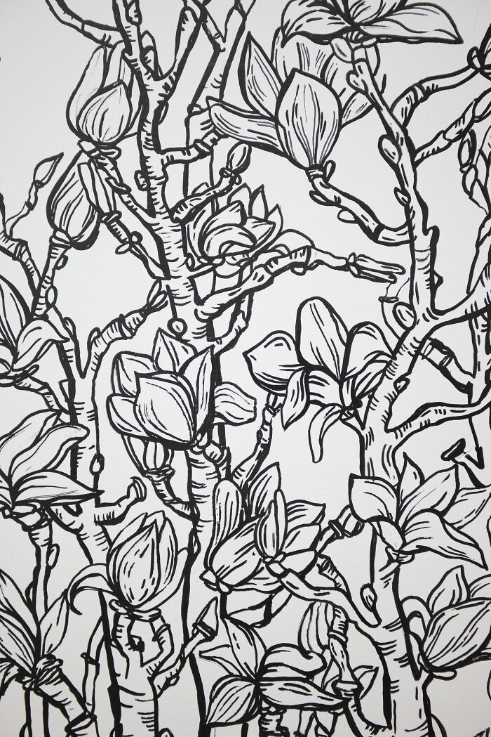 Black and white 2D drawing of blooming flowers and branches on a restaurant wall in NYC creating a sketch-like effect. Black and white 2D drawing of blooming flowers and branches on a restaurant wall in NYC creating a sketch-like effect.