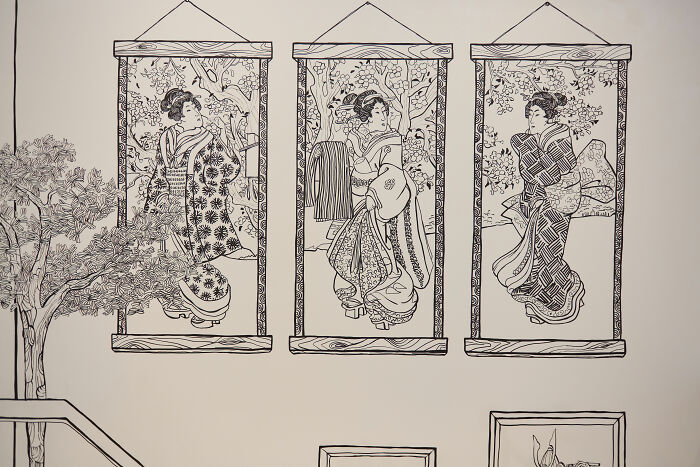 Wall art inside the 2D restaurant in NYC featuring intricate black and white drawings of traditional Japanese figures. Wall art inside the 2D restaurant in NYC featuring intricate black and white drawings of traditional Japanese figures.