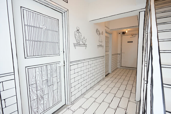 2D restaurant interior in NYC with black and white drawn walls and floors creating a comic book style space. 2D restaurant interior in NYC with black and white drawn walls and floors creating a comic book style space.