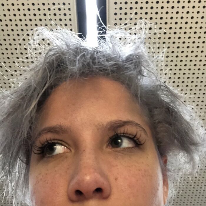 Close-up of a person with wild, messy hair illustrating a hilariously tragic hair accident indoors.