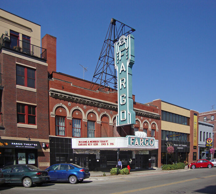 Fargo city street with theater sign under clear blue sky showcasing incredible weather records on a powerful planet.