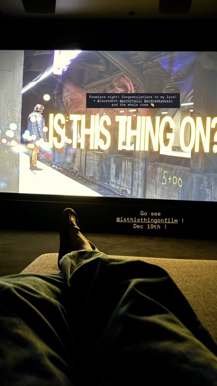 Person relaxing in front of a screen showing a film scene with Gigi Hadid and Bradley Cooper partnership.