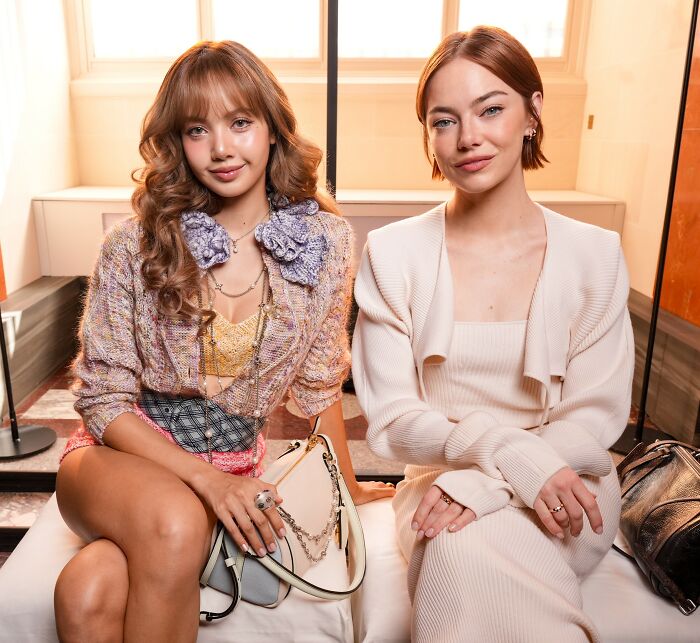 Emma Stone sitting in a Louis Vuitton outfit with another woman, sparking plastic surgery speculation in photoshoot. Emma Stone sitting in a Louis Vuitton outfit with another woman, sparking plastic surgery speculation in photoshoot.