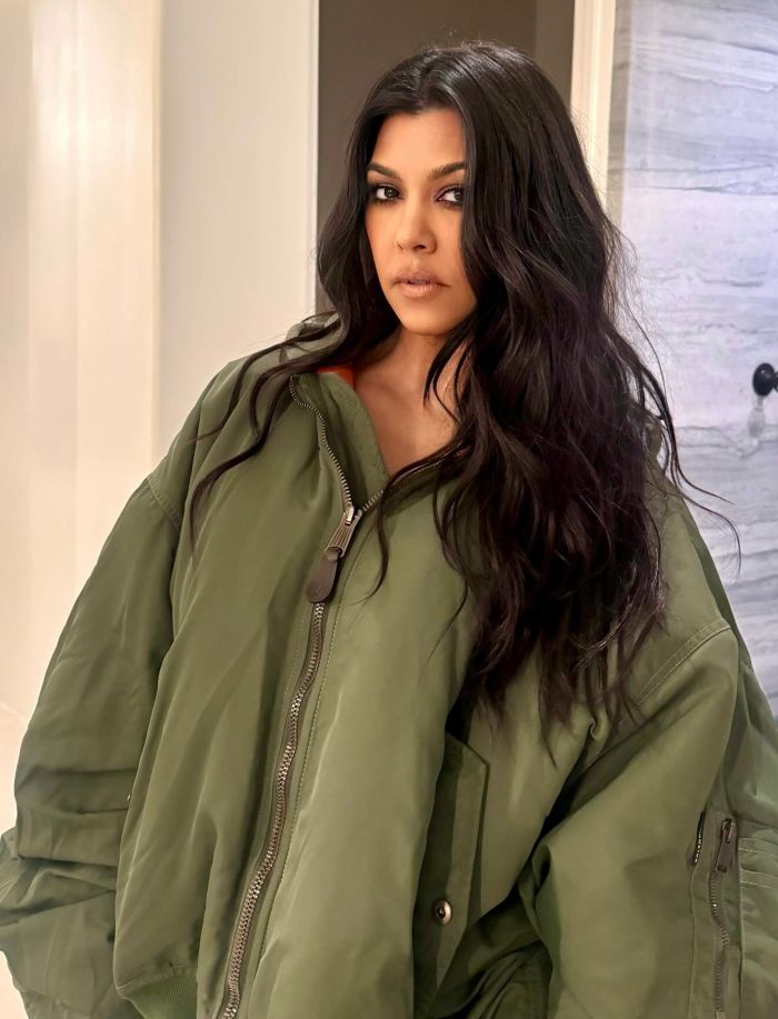 Kourtney Kardashian wearing a green jacket, posing indoors related to lollipops for women’s private parts launch. Kourtney Kardashian wearing a green jacket, posing indoors related to lollipops for women’s private parts launch.