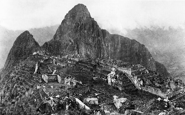 Black and white vintage photo of historic Machu Picchu showcasing early photography capturing ancient ruins.