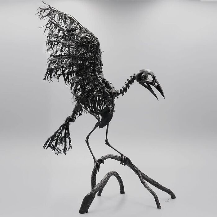 Haunting porcelain sculpture of a skeletal bird with tattered wings perched on twisted branches resembling relics of forgotten myths.