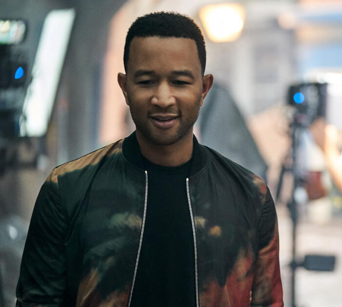 Man in a casual jacket and black shirt on set, representing unknown things about celebrities shared by people who met them