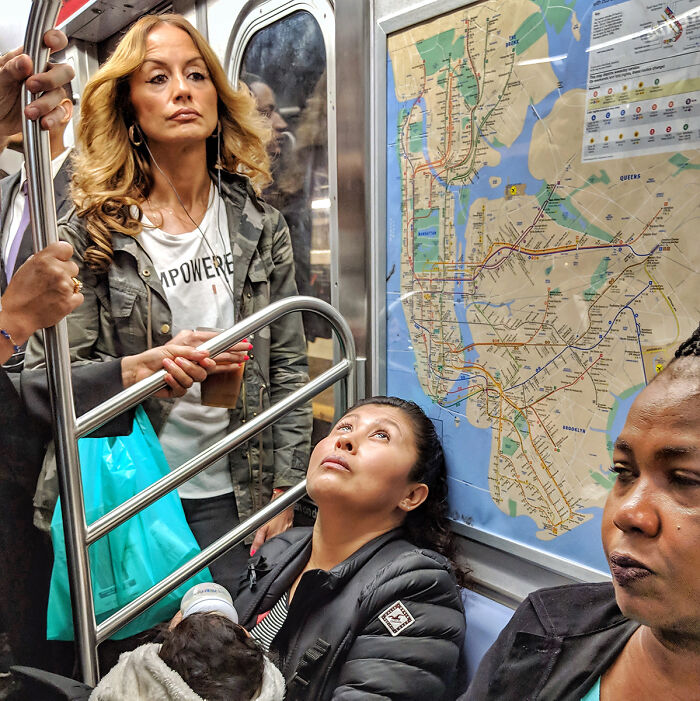 Diverse passengers captured in candid subway portrait with NYC subway map in background, showcasing life underground.