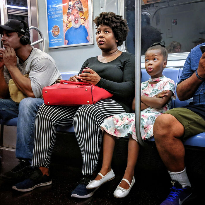 Diverse passengers seated in NYC subway car, capturing candid moments of life underground in street portraits.