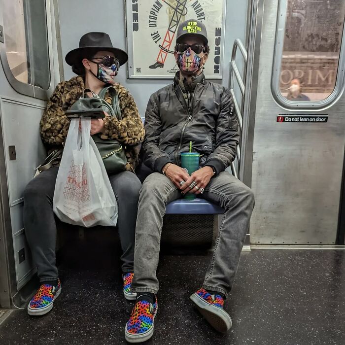 Two subway riders wearing colorful leopard print shoes and patterned face masks captured in a NYC street portrait.