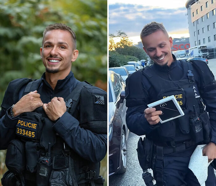 Smiling police officer in uniform reacts happily while looking at his portrait in an outdoor urban setting.