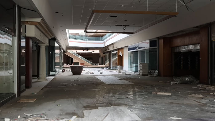 Abandoned ghost mall interior with debris and dim lighting where urban explorers found a trapped dog needing rescue. Abandoned ghost mall interior with debris and dim lighting where urban explorers found a trapped dog needing rescue.