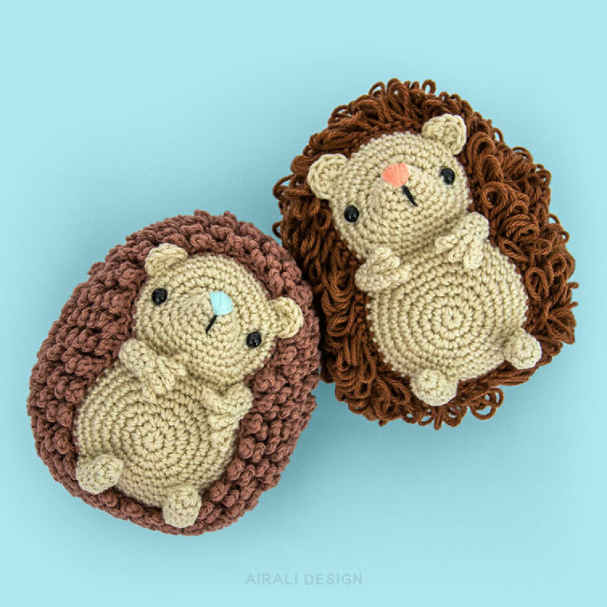 Two crochet animal hedgehogs with detailed curly brown and tan yarn, showcasing personality and handcrafted charm.