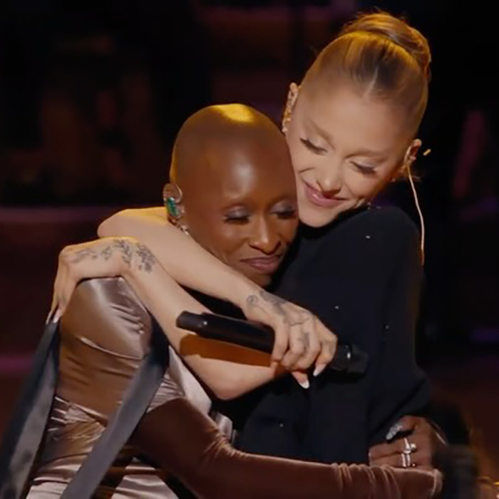 Ariana Grande embracing a fellow performer on stage, showcasing her dramatic new look amid fan backlash. Ariana Grande embracing a fellow performer on stage, showcasing her dramatic new look amid fan backlash.