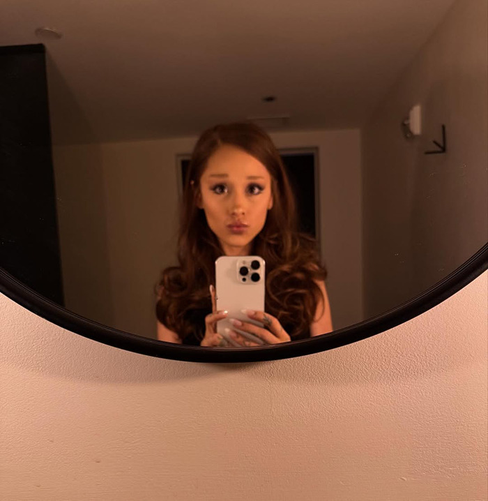 Ariana Grande taking a mirror selfie showing her dramatic new look that sparked backlash from fans. Ariana Grande taking a mirror selfie showing her dramatic new look that sparked backlash from fans.