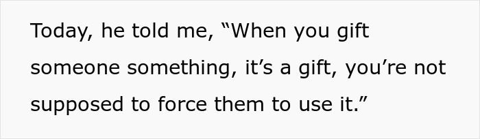 Text on a white background showing a quote about gifting, related to boyfriend refusing to hang anniversary gift on wall.