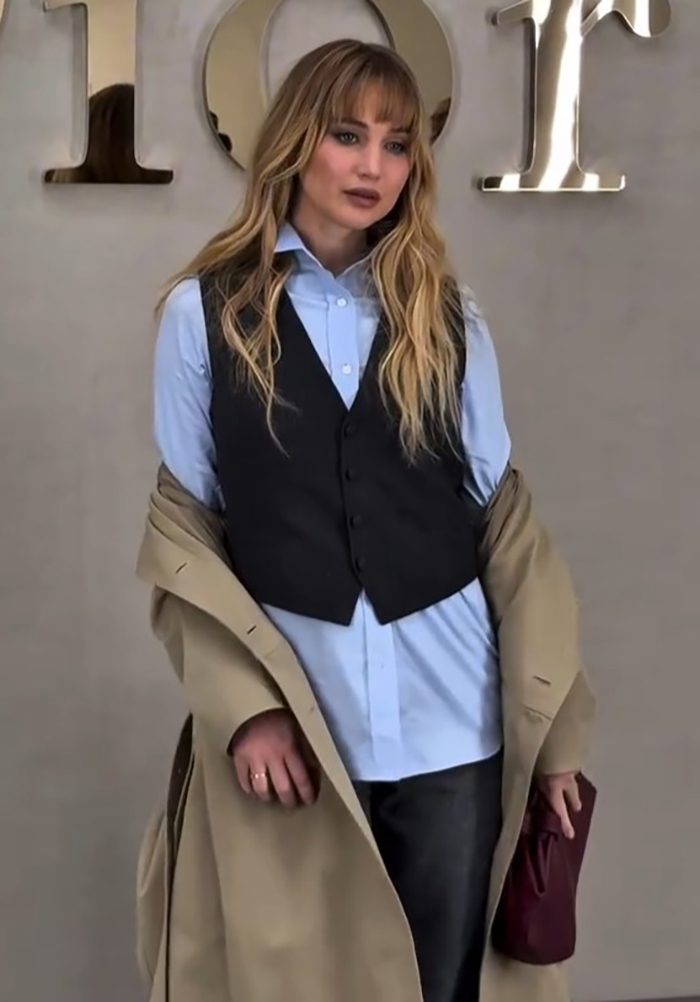Jennifer Lawrence posing in layered outfit at Paris Fashion Week, sparking buzz around plastic surgeon topic in LA. Jennifer Lawrence posing in layered outfit at Paris Fashion Week, sparking buzz around plastic surgeon topic in LA.