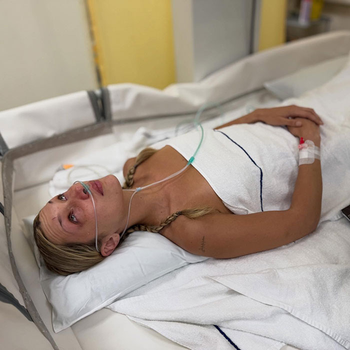 Victoria's Secret model lying in hospital bed with oxygen tube, showing the dark sides of model lives and health struggles. Victoria's Secret model lying in hospital bed with oxygen tube, showing the dark sides of model lives and health struggles.