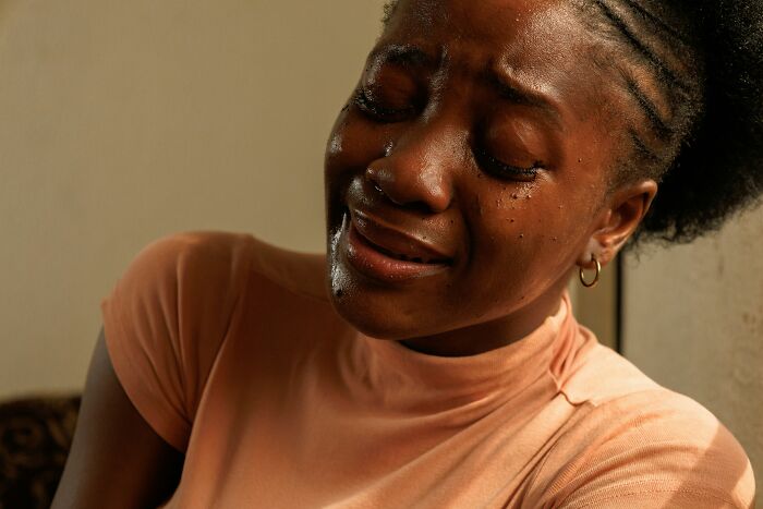 Pregnant woman crying with tears streaming down her face, showing emotional pain and distress indoors. Pregnant woman crying with tears streaming down her face, showing emotional pain and distress indoors.