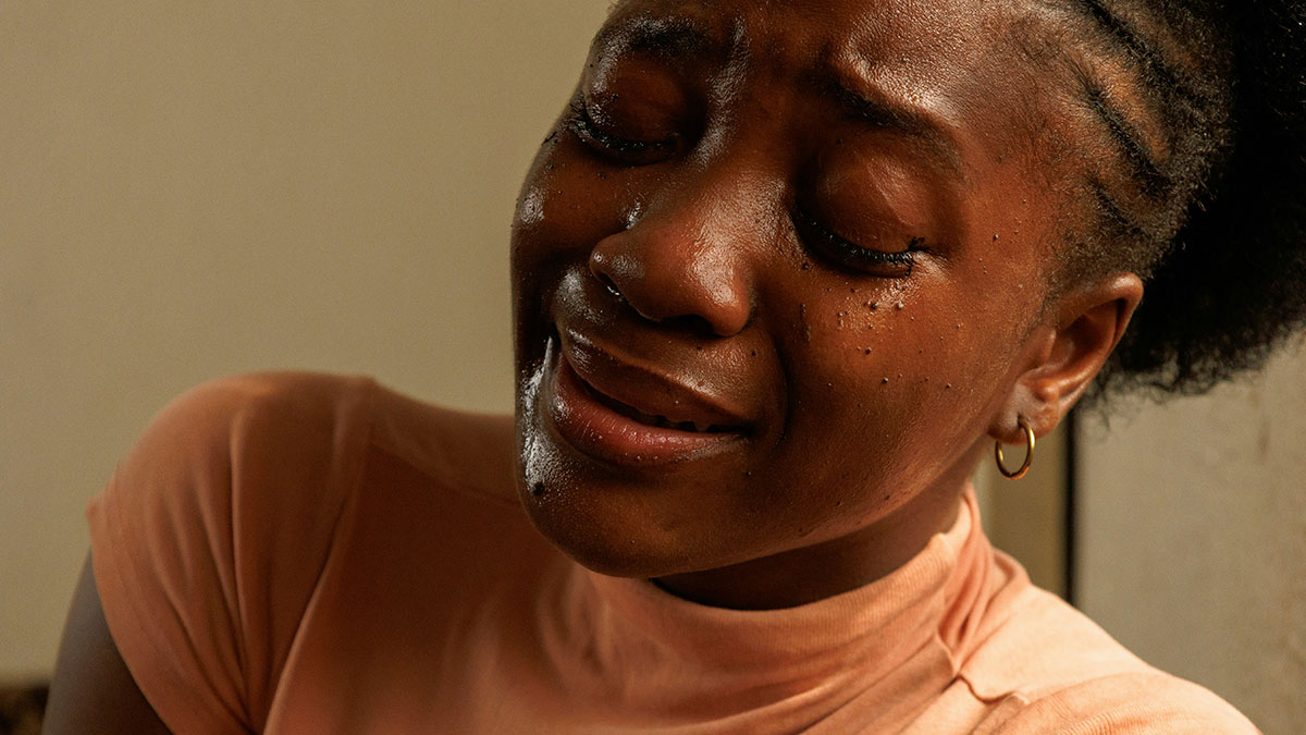 Pregnant woman with tears on her face, showing emotional distress after humiliation by bestie and ex partner.