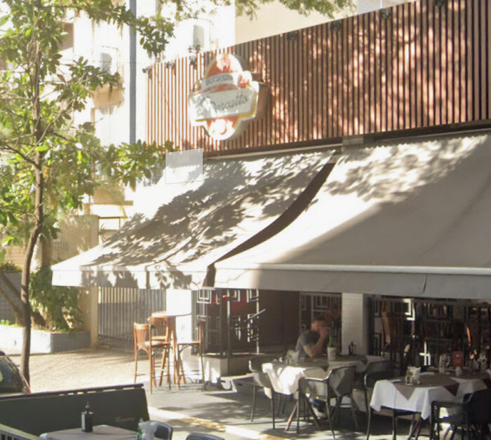 Outdoor café with tables and chairs under awning, capturing children come first concept in peaceful urban setting. Outdoor café with tables and chairs under awning, capturing children come first concept in peaceful urban setting.