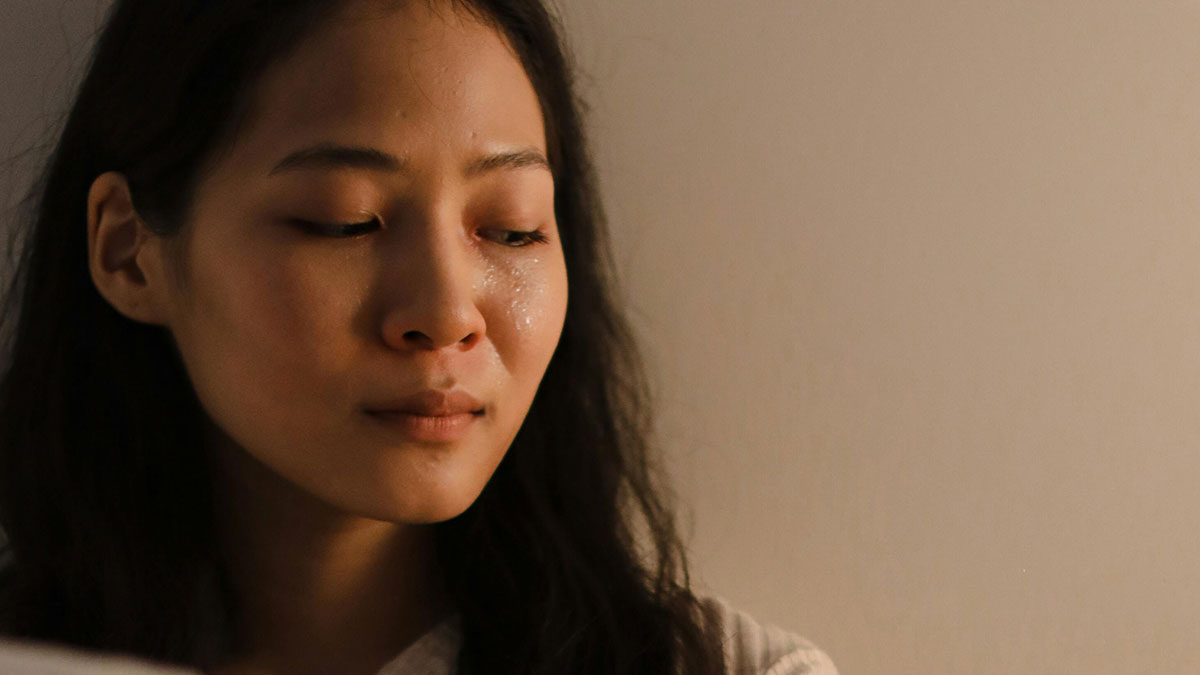 Young woman with tear-streaked face, reflecting on a man with debt asking her to take a loan for a Spider-Man costume.