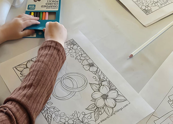 Bridesmaid coloring wedding rings in floral frame with colored pencils before ceremony, bride reacts upset.