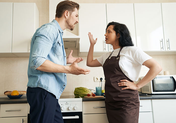 Woman in apron arguing with brother about live-in nanny job demands in kitchen setting Woman in apron arguing with brother about live-in nanny job demands in kitchen setting