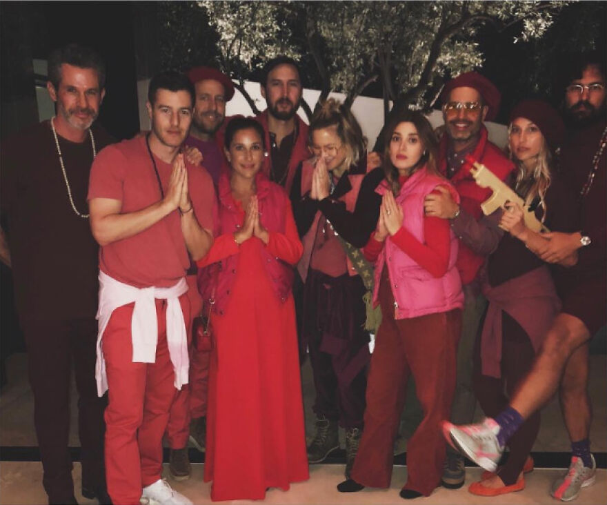 Group of celebrities in colorful Halloween costumes posing together, showing lack of common sense in their outfits.