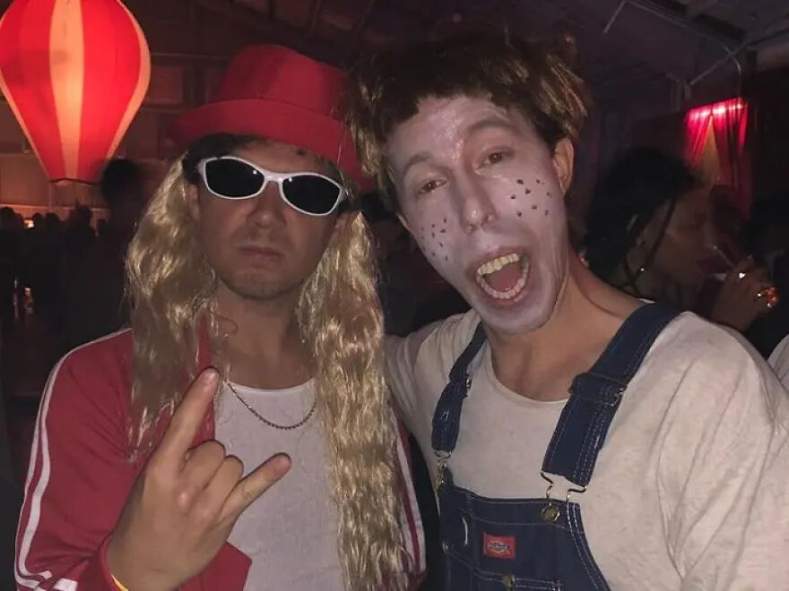 Two men in Halloween costumes at a party, showcasing celebrities and common sense missing from their outfits.