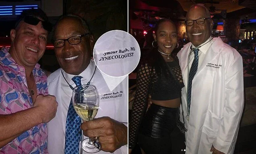 Man dressed as a gynecologist with a labeled coat posing with party guests, showing lack of common sense in Halloween costume.