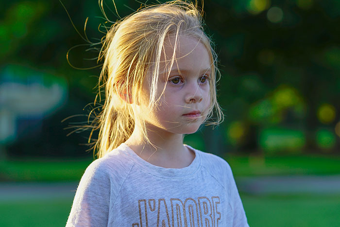 Five-year-old girl standing outside looking thoughtful after parents abandon her in another city as a lesson. Five-year-old girl standing outside looking thoughtful after parents abandon her in another city as a lesson.