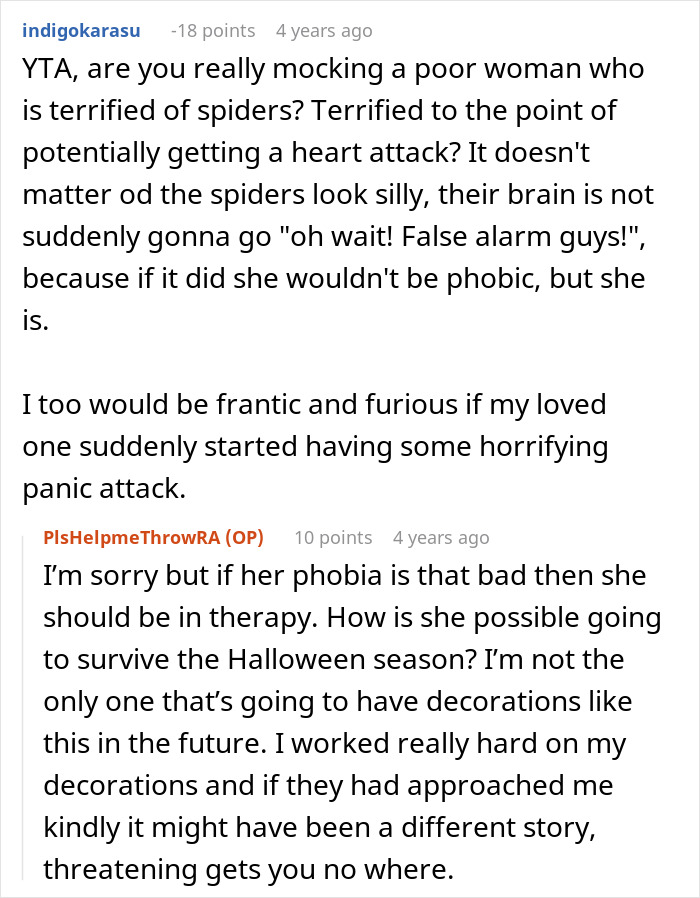 Red and black Halloween spider decoration with a spider web covering the porch, showcasing spooky Halloween decor.