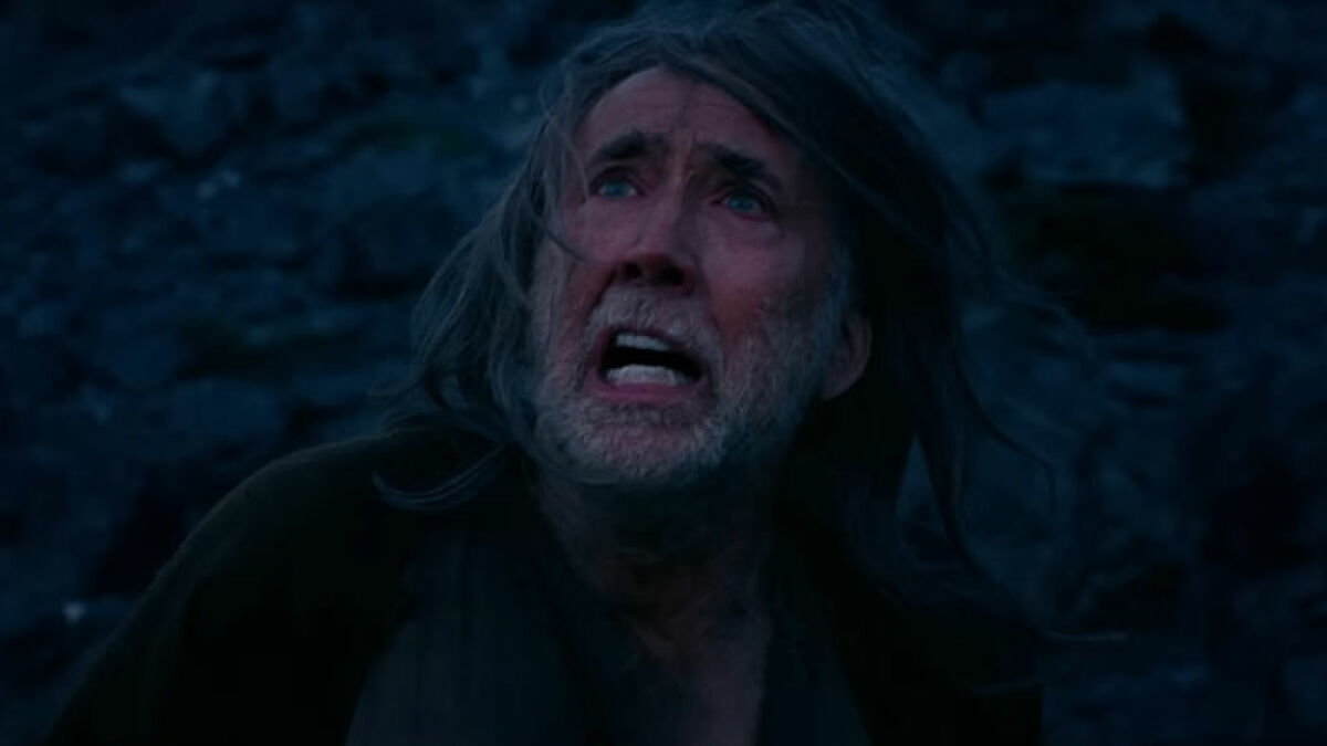 Nicolas Cage with long hair and beard, looking upward dramatically in new horror film as Jesus' dad.