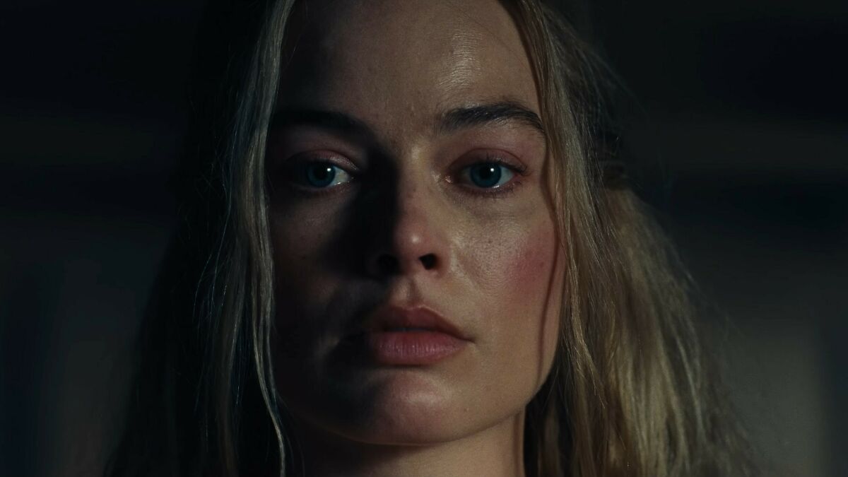 Close-up of Margot Robbie with intense expression in the provocative Wuthering Heights trailer scene.