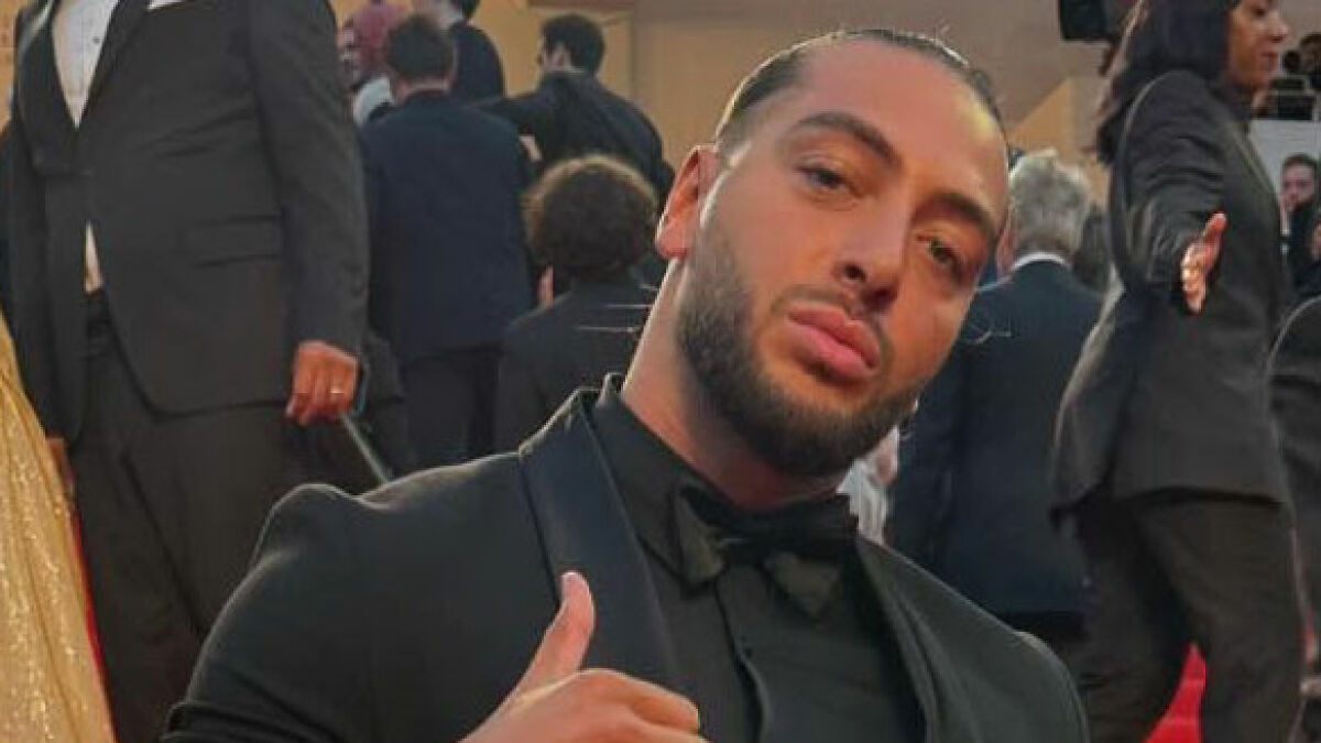 Man in tuxedo at event, relating to influencer's fake syringe attack pranks causing arrest and public outrage.