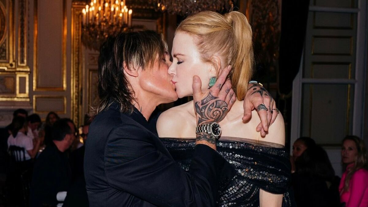 Nicole Kidman and Keith Urban sharing a kiss at a glamorous event, highlighting intimacy amid divorce news.