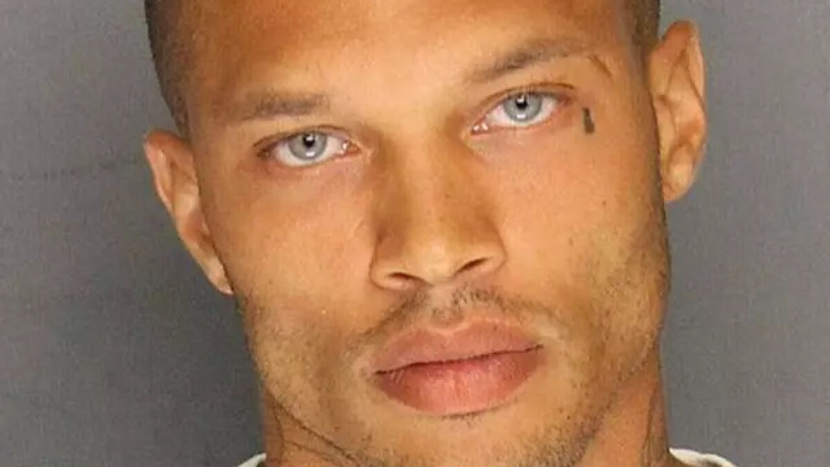 Close-up of the world's hottest felon with blue eyes and a teardrop tattoo on his face.