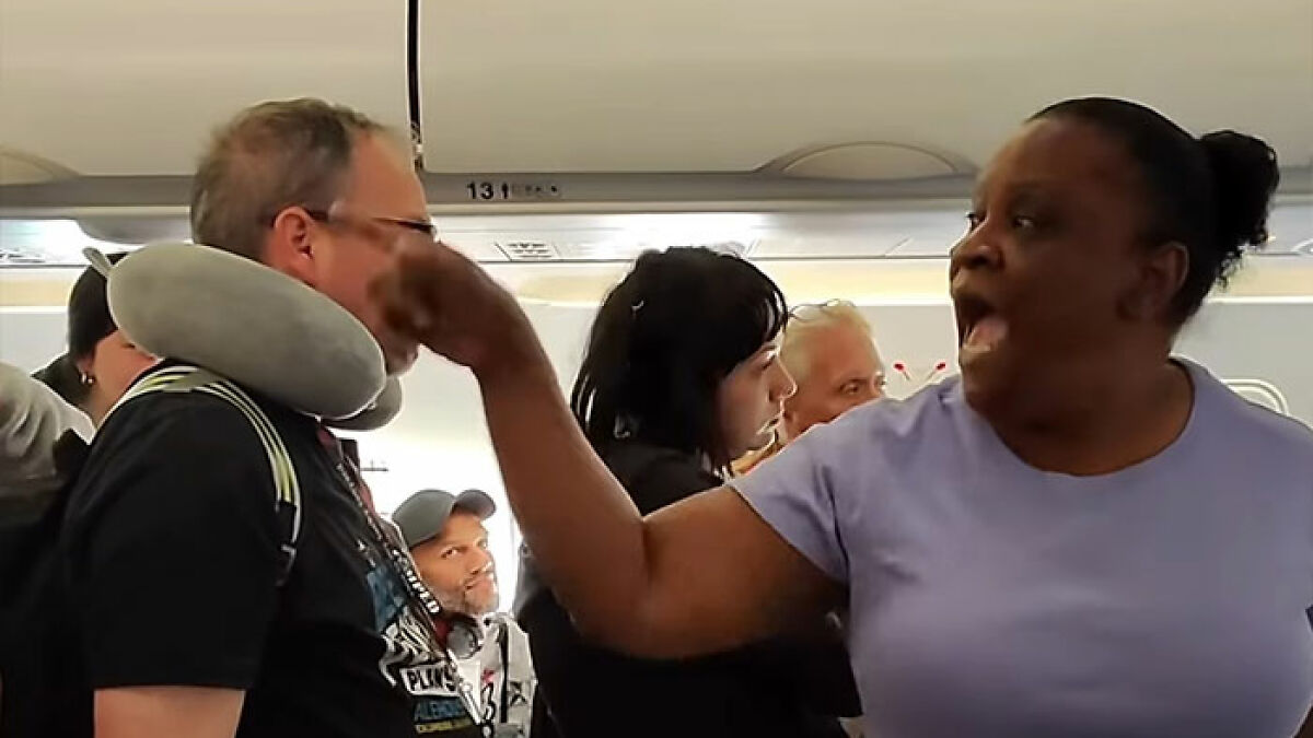 Woman refusing to let passengers exit airplane until her daughter goes first, causing outrage among travelers.