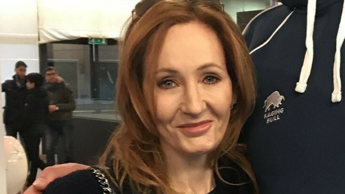 J.K. Rowling smiling in a casual setting while Harry Potter event organizers apologize to transgender community.