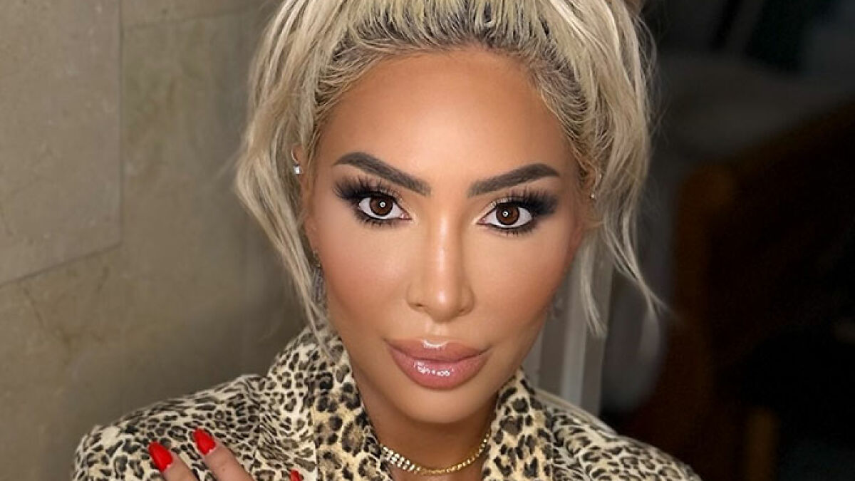 Farrah Abraham with blonde hair and leopard print, called out for letting her 16-year-old daughter get a pelvic tattoo.