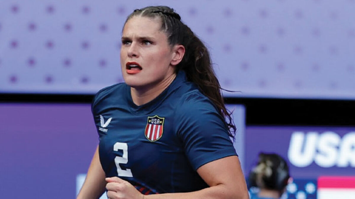 Olympic athlete Ilona Maher running on court in USA team uniform, challenging considered overweight stereotypes in sports.